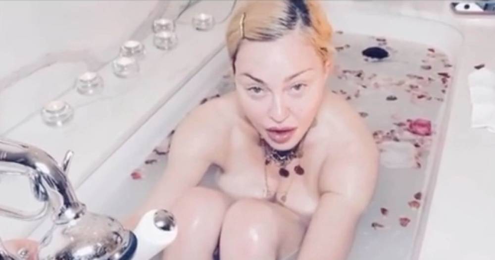 Madonna slammed for praising coronavirus for being 'the great equaliser' in bizarre naked bath video - ok.co.uk - Britain