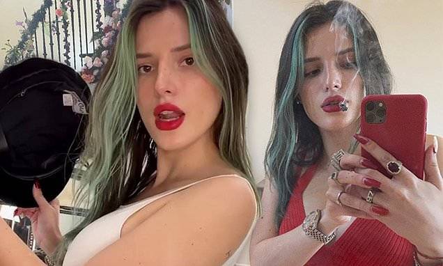 Bella Thorne - Bella Thorne flashes her taut tummy in a red crop top while relaxing with a joint - dailymail.co.uk