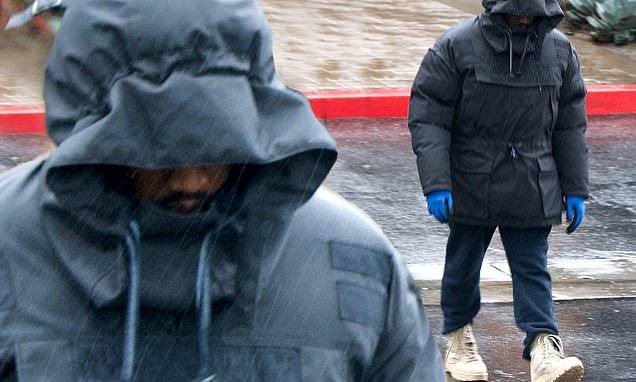 Kanye West leaves Yeezy office all bundled up in a rain coat and gloves amid coronavirus pandemic - dailymail.co.uk - state California