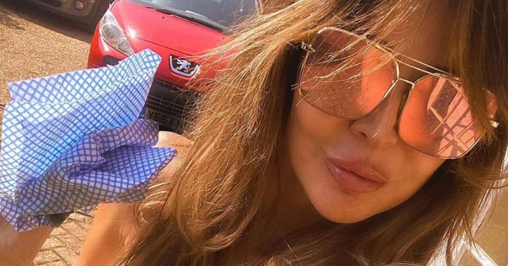 Lizzie Cundy - Lizzie Cundy sees cleavage spill from swimsuit slashed to navel for cleaning session - dailystar.co.uk