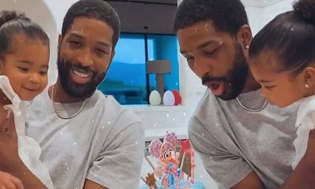 Khloe Kardashian - Tristan Thompson - Tristan Thompson cradles daughter True as they blow out the candles on her second birthday cake - dailymail.co.uk