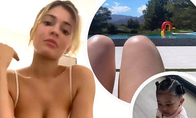 Kylie Jenner - Kylie Jenner flashes her legs as she sunbathes by the swimming pool - dailymail.co.uk