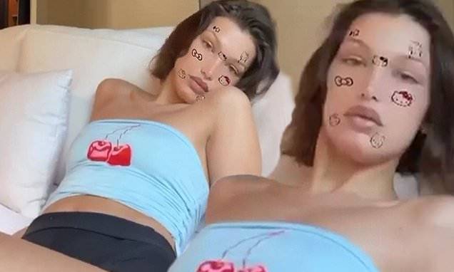 Bella Hadid - Bella Hadid gets flirty as she flaunts curves in skimpy shorts and tube top with Hello Kitty filter - dailymail.co.uk - state Pennsylvania