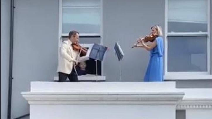 Doctor and husband perform balcony violin concert for neighbors shut in amid COVID-19 lockdowns - fox29.com