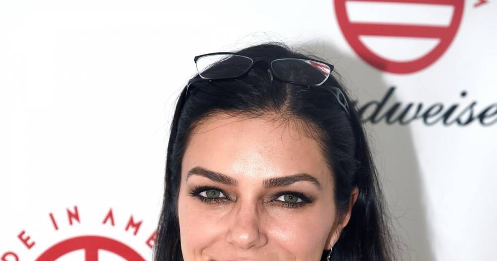 'ANTM' alum Adrianne Curry reflects on removing breast implants - wonderwall.com