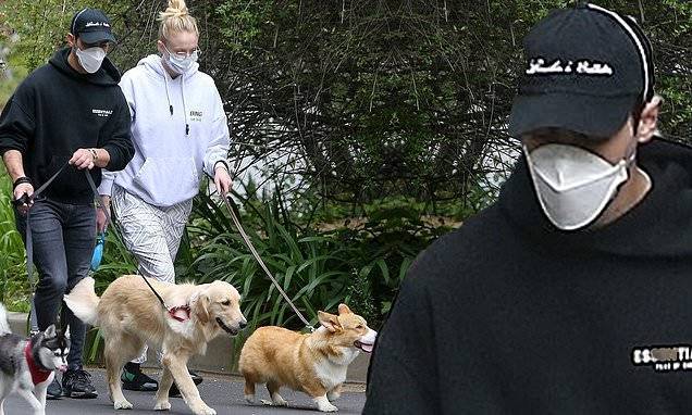 Joe Jonas and expecting wife Sophie Turner take their pooches for a walk in hoodies and face masks - dailymail.co.uk