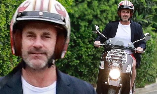 Jon Hamm - Jon Hamm rides his scooter to a friend's house amid COVID-19 stay-at-home orders - dailymail.co.uk - Los Angeles - state California - city Los Angeles