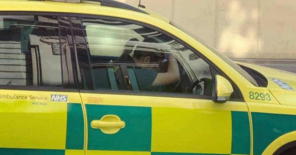 NHS paramedic pictured with head in hands begs public to ‘stay at home' to beat virus - mirror.co.uk