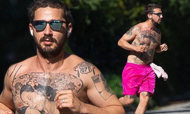 Mia Goth - Shia Labeouf - Shia LaBeouf revealed his heavily tattoo torso as he goes shirtless for a run in hot pink shorts - dailymail.co.uk - Los Angeles - state California