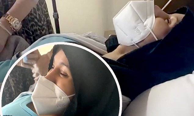 Cardi B howls in pain through her face mask as she appears to get a bikini wax - dailymail.co.uk