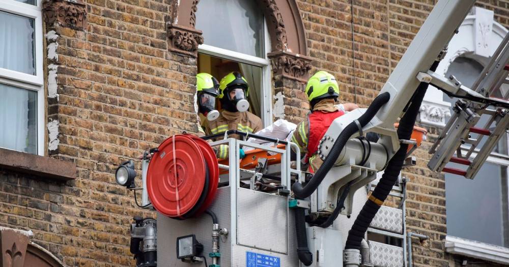Coronavirus: Firefighters use crane in dramatic scenes to rescue man from flat - dailystar.co.uk - Britain - London