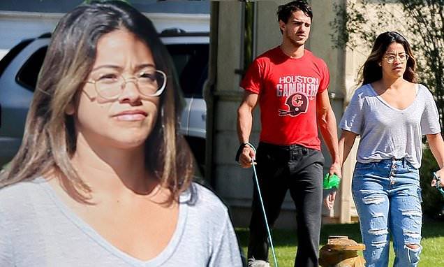 Gina Rodriguez - Gina Rodriguez steps out in v-neck top and ripped jeans to walk the dogs with hubby Joe LeCicero - dailymail.co.uk