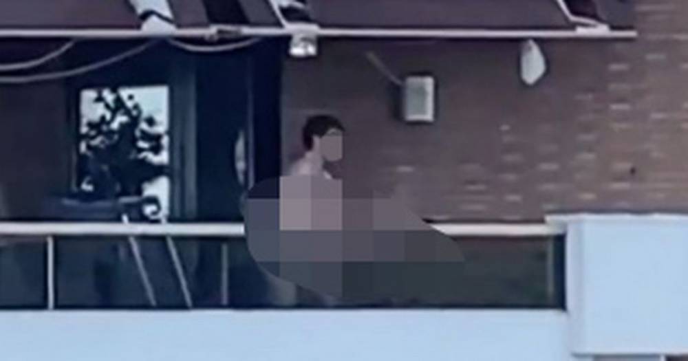 Couple have sex on balcony in full view of neighbours in outrageous video - dailystar.co.uk - Spain
