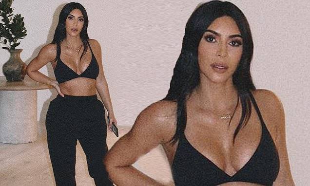 Kim Kardashian - Kim Kardashian flaunts her flat midsection and ample cleavage in bralette and sweats from her brand - dailymail.co.uk