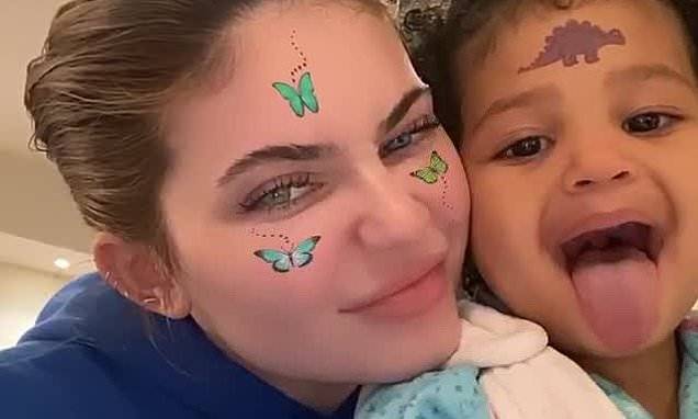 Travis Scott - Kylie Jenner's daughter Stormi, two, sticks her tongue out as she shows off her dinosaur 'tattoo' - dailymail.co.uk - state California - county Hill
