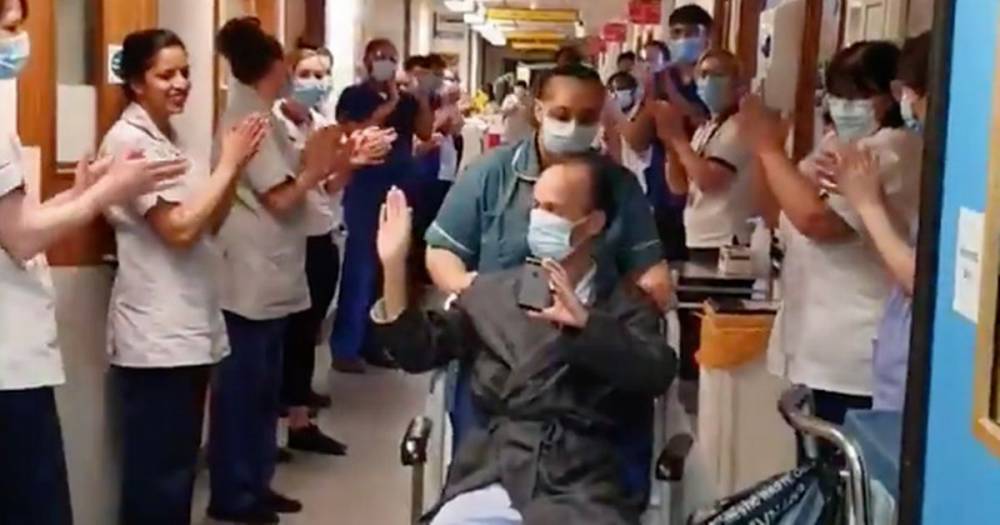 NHS staff clap coronavirus survivor out of hospital in heartwarming footage - dailystar.co.uk