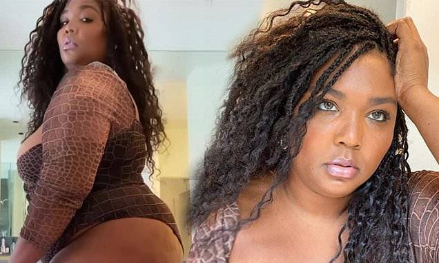 Lizzo plays around with colored contacts during sultry self-isolation photo shoot - dailymail.co.uk