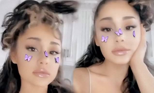 Ariana Grande shows off her long curly locks in Instagram video as she reverts to her natural look - dailymail.co.uk
