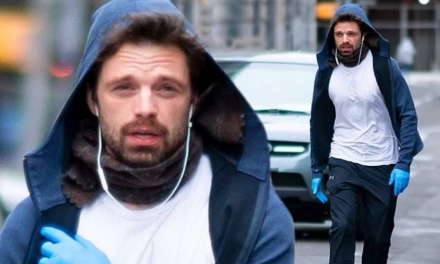 Sebastian Stan - Sebastian Stan tunes out the world as he strolls on the street wearing his earbuds and latex gloves - dailymail.co.uk - city New York - Romania