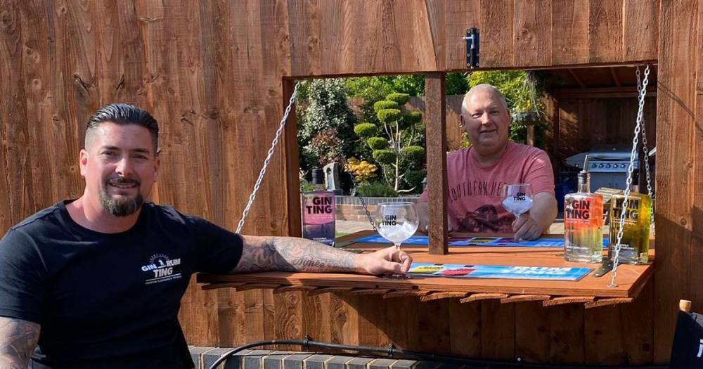 Neighbours get around lockdown by constructing gin bar in a hole in their fence - dailystar.co.uk