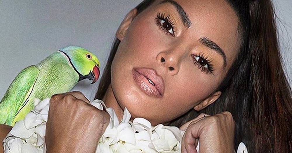 Kim Kardashian - Kim Kardashian poses naked with parrot in 'tropical vibes' lockdown promotion - mirror.co.uk - city Malibu