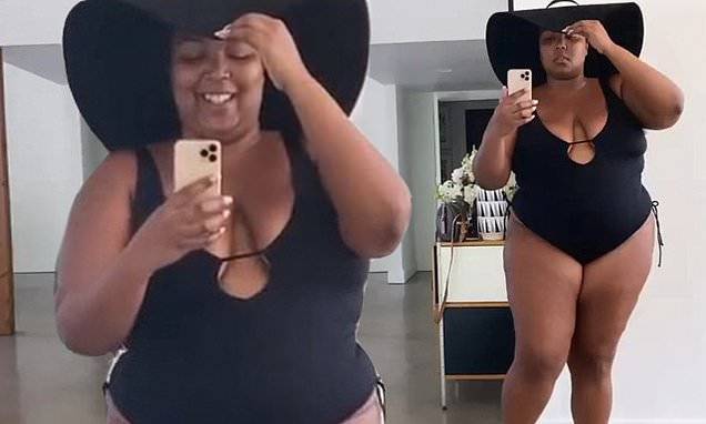 Lizzo turns up the heat as she puts her curves on display in plunging black bathing suit - dailymail.co.uk