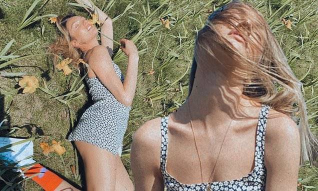 Candice Swanepoel shows off her stunning figure while soaking in the sun in a field of flowers - dailymail.co.uk - South Africa