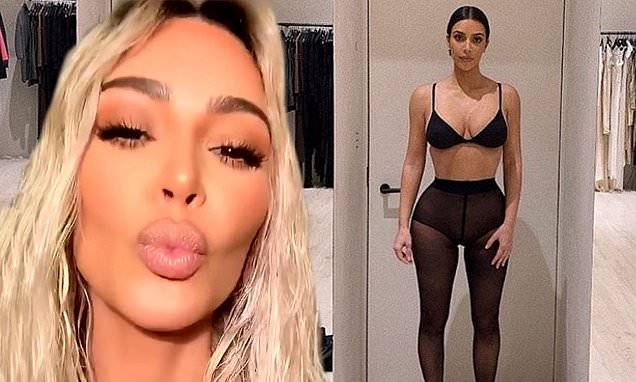 Kim Kardashian - Kim Kardashian displays her signature curves in black as she admits blonde beach waves were a wig - dailymail.co.uk