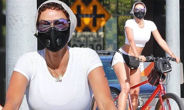 Nicole Murphy - Nicole Murphy flaunts her trim tummy in a white crop top as she stays in shape with a bike ride - dailymail.co.uk
