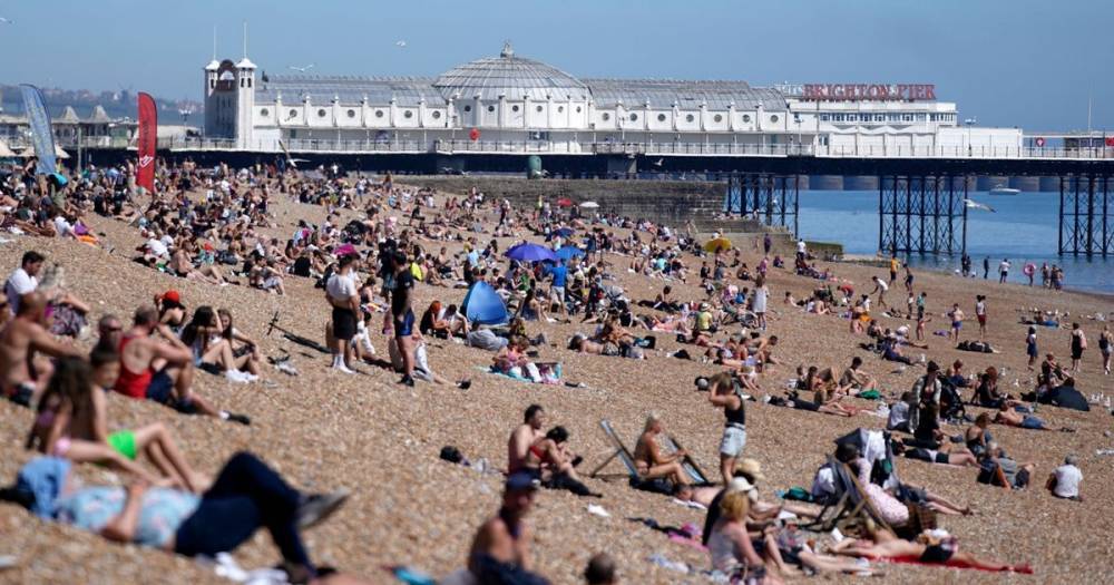 Brits 'forget coronavirus' as thousands pack out beaches on hottest day of year so far - dailystar.co.uk