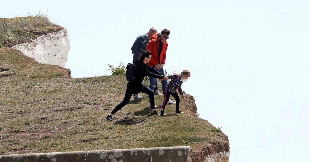 Terrifying close call as parents drag little girl back from edge of 400ft cliff - dailystar.co.uk