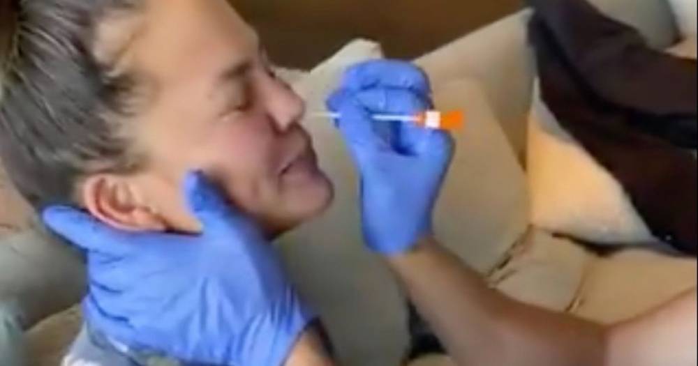 Chrissy Teigen - Chrissy Teigen squeals as she gets a nose swab during coronavirus test - mirror.co.uk