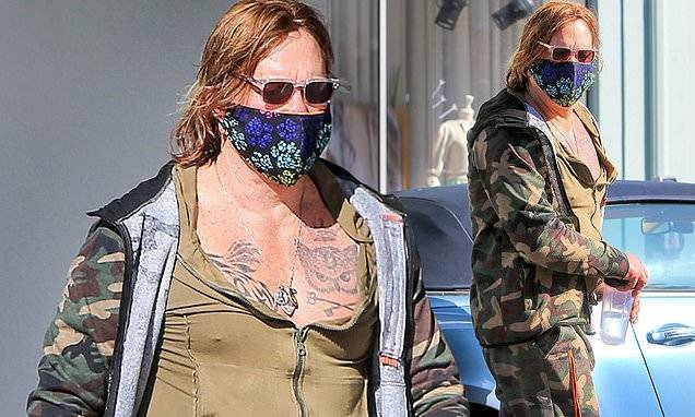 Mickey Rourke - Mickey Rourke cuts a colorful figure in camouflage outfit and bright face mask - dailymail.co.uk - Latvia