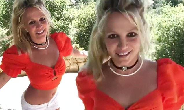 Kim Petras - Britney Spears shows off abs in an orange crop-top as she dances to Kim Petras' song Malibu - dailymail.co.uk