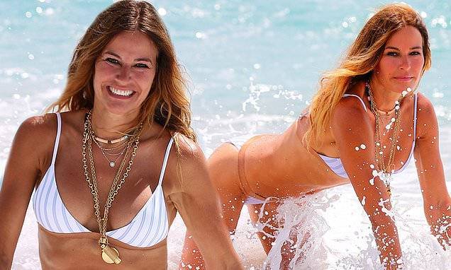 RHONY alum Kelly Bensimon gets wet and wild in her striped bikini while crawling in Palm Beach surf - dailymail.co.uk - city New York - county Palm Beach - city Columbia