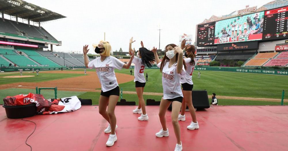 Korean baseball returns as cheerleaders wearing masks perform at empty stadiums - dailystar.co.uk - South Korea - North Korea