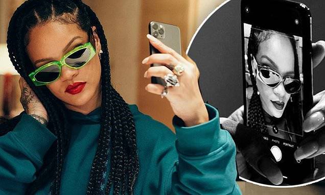 Rihanna is her own best advertisement as she models a pair of electric green Fenty sunglasses - dailymail.co.uk