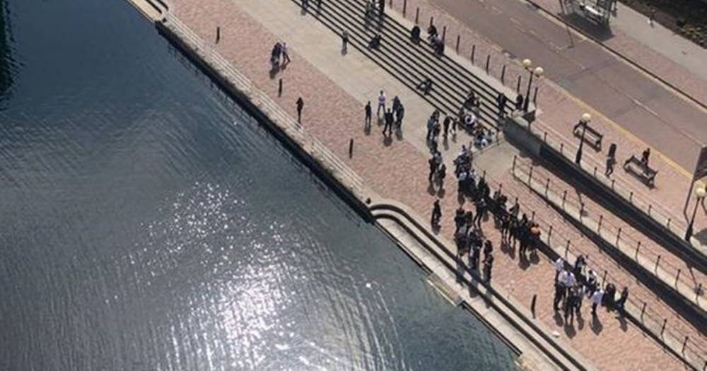 Police break up group of 'up to 100 people' spraying and drinking champagne at Salford Quays - manchestereveningnews.co.uk