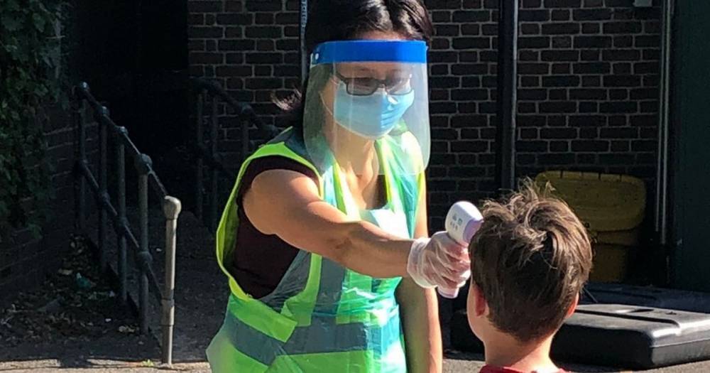 Teacher wearing face shield checks pupils' temperatures as they return to school - mirror.co.uk - city London