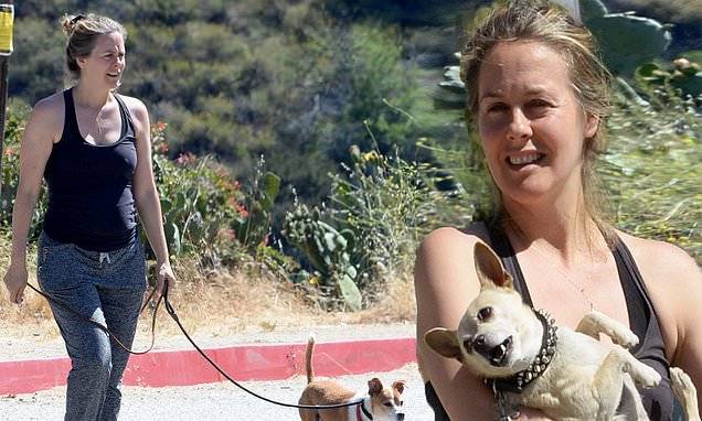 Alicia Silverstone - Alicia Silverstone cuddles up to one of her dogs...after saying she bathes with son - dailymail.co.uk - Los Angeles