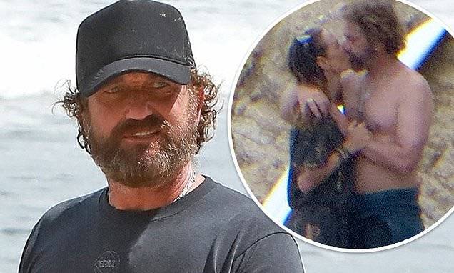 Morgan Brown - Gerard Butler walks on beach in Malibu after kissing longtime girlfriend Morgan Brown on the sand - dailymail.co.uk - state California - Scotland - county Morgan - city Malibu, state California