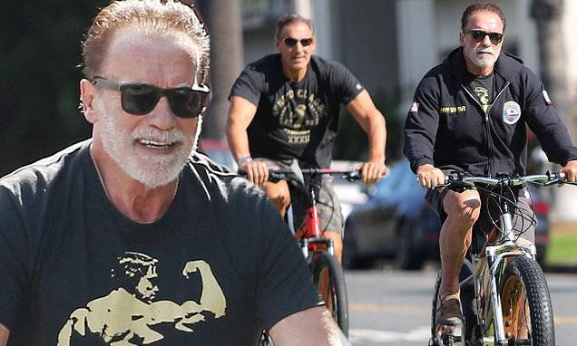 Arnold Schwarzenegger - Ralf Moeller - Arnold Schwarzenegger takes in the morning breeze as he goes for his daily bike ride - dailymail.co.uk