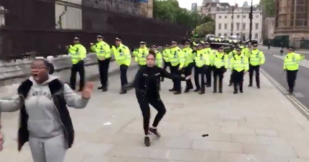 Boris Johnson - Brave woman steps in front of protest crowds to stop objects being hurled at police - mirror.co.uk - city London