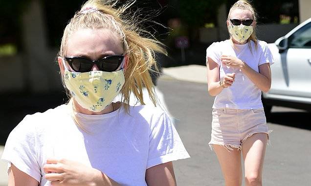 Dakota Fanning runs errands in t-shirt and denim cutoffs while wearing apatterned face mask in LA - dailymail.co.uk - Los Angeles