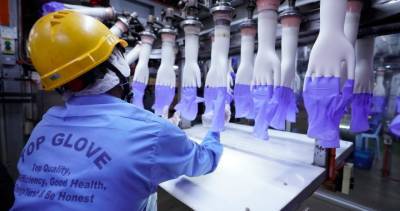 Coronavirus outbreak at world’s largest maker of latex gloves slows production - globalnews.ca - city Kuala Lumpur