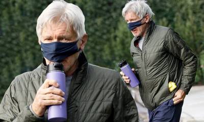Harrison Ford lifts his mask to sip some water before an early morning tennis match in Brentwood - dailymail.co.uk - Usa - state California - county Harrison - county Ford