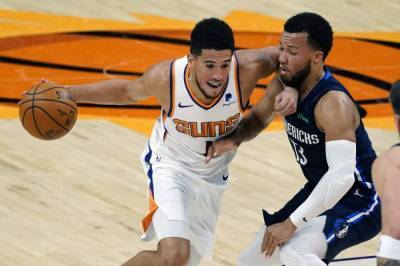 Chris Paul - Devin Booker - Luka Doncic - Booker, Bridges lead new-look Suns past Mavericks 106-102 - clickorlando.com - county Dallas - county Maverick