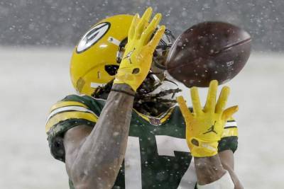 Aaron Rodgers - Aaron Jones - Adams shines in snow as Packers trounce Titans 40-14 - clickorlando.com - San Francisco - county Bay - state Tennessee - city Seattle - city Boston - city Chicago - county Adams - state Wisconsin - county Green