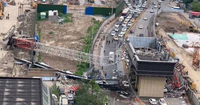 Huge crane collapses onto busy motorway trapping terrified woman in car - mirror.co.uk - China - city Wuhan