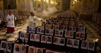 Powerful image of archbishop in cathedral surrounded by pictures of Covid-19 victims - mirror.co.uk - Usa - city Lima - Peru